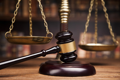 A Judge's gavel rests on a desk.